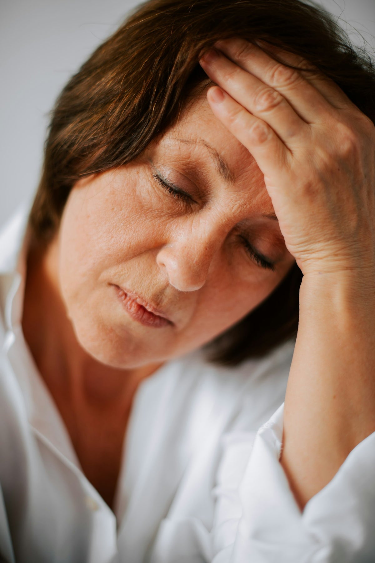 Woman holding her head due to tension headache